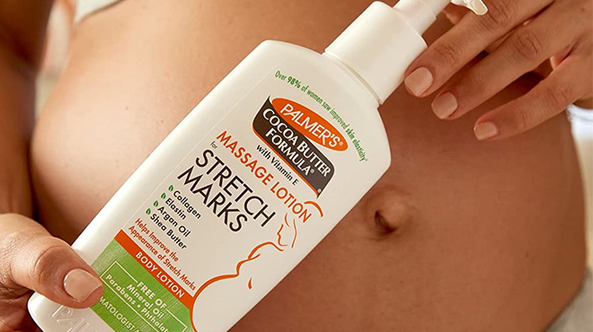 Pregnant Woman Holding a Palmers Cocoa Butter Massage Lotion for Stretch Marks