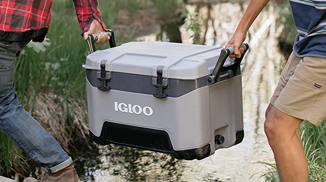 Two People Carrying Igloo BMX 52 Quart Cooler