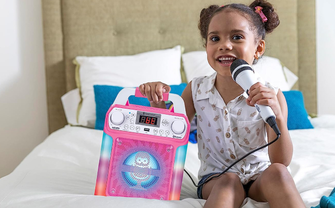 A Girl Singing on Her Portable Karaoke Machine