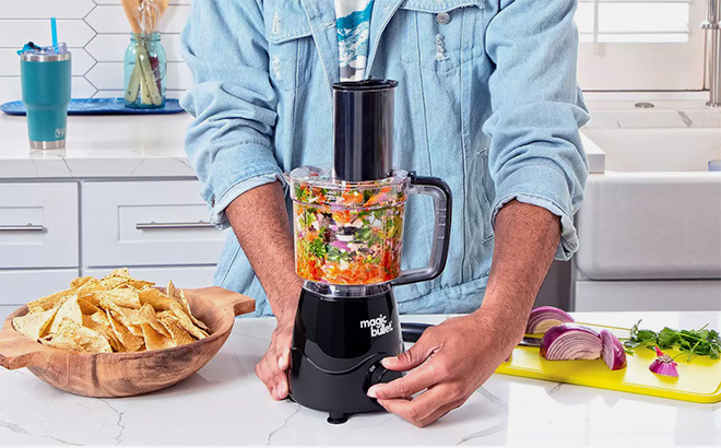 A Man Using the NutriBullet Magic Bullet Kitchen Prep Food Chopper in the Kitchen