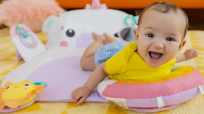 Baby using a Bright Starts Prop Play Unicorn Baby Mat