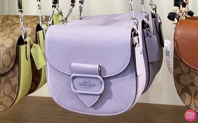 Coach Saddle Bag Hanging from Store Shelf