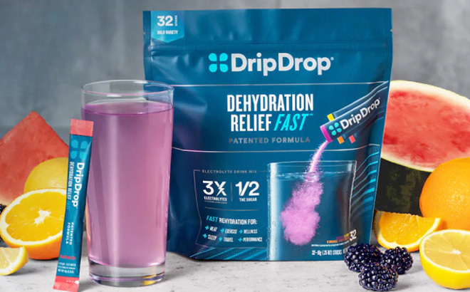 DripDrop Electrolyte Powder Drink Variety Pack on Table Surrounded by Fruit