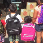 Four Kids Wearing Free Backpacks from Verizon