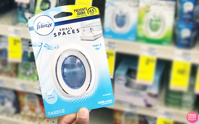 Hand Holding Febreze Small Spaces Air Freshener in the Scent Linen Sky at Walgreens