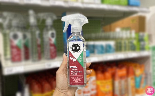 Hand Holding a Stem Plant Based Insect Spray Bottle