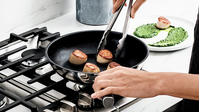 Person Cooking in a Ninja Foodi NeverStick Stainless 8 Inch Fry Pan