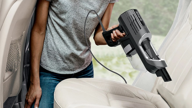 Woman Cleaning the Inside of a Car with the Shark UltraLight Corded Handheld Vacuum