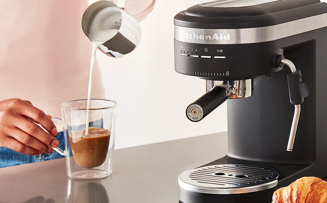 Woman Making a Coffee on the KitchenAid Semi Automatic Espresso Machine