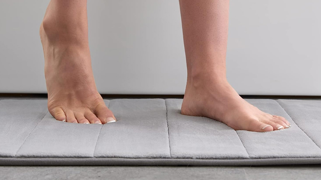 Woman Stepping on a Memory Foam Non Slip Water Absorbent Bath Mat