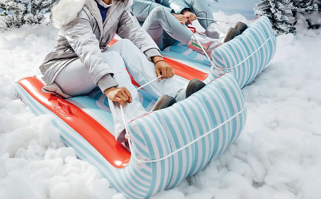 Women Sledding on the Funboy Candy Cane Toboggan Winter Snow Sled