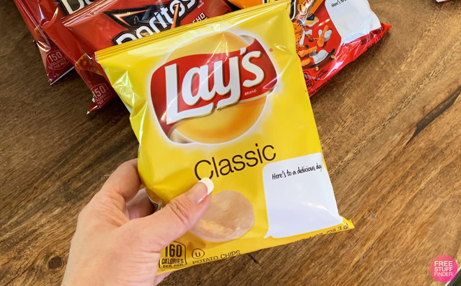 a Hand Holding Lays Classic Potato Chips Bag