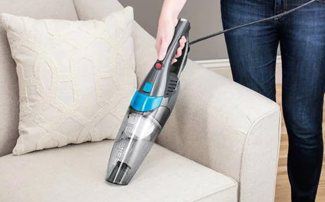 a Person Using a Bissell 3 in 1 Lightweight Corded Stick Vacuum 2030