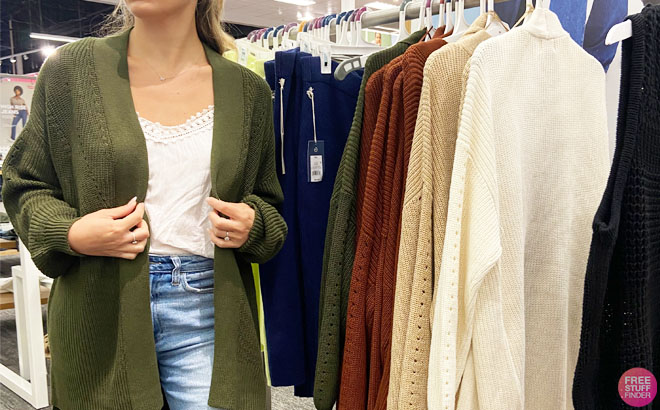 a Woman Trying a Fall Cardigan on in a Store