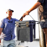 two Men Holding a Yeti Roadie 24 Cooler