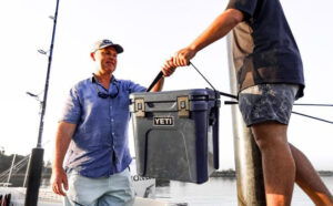 two Men Holding a Yeti Roadie 24 Cooler