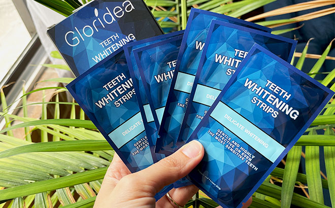 A Hand Holding Gloridea Teeth Whitening Strips 1