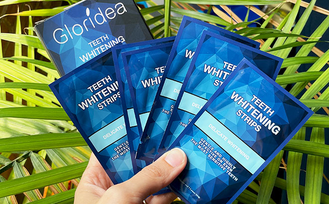 A Hand Holding Gloridea Teeth Whitening Strips