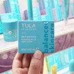 A Woman Holding Tula 24-7 Moisture Hydrating Day & Night Cream