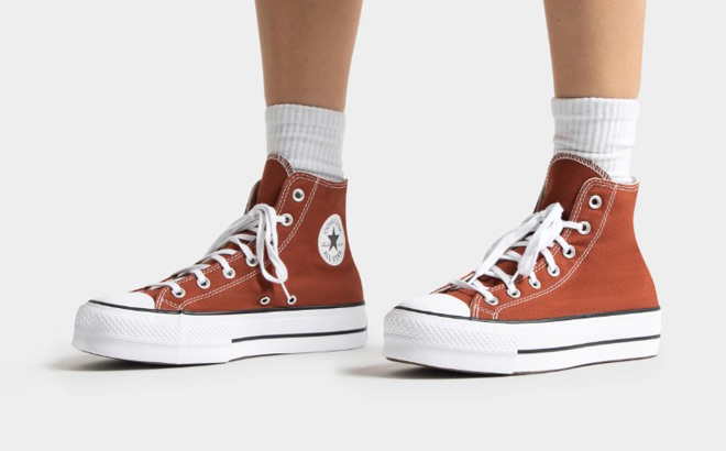 A Woman Wearing Coverse Chuck Taylor All Star Lift Platform Shoes