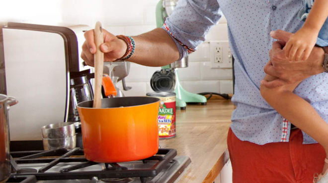 A hand cooking Chef Boyardee Mini ABCs and 123s Pasta