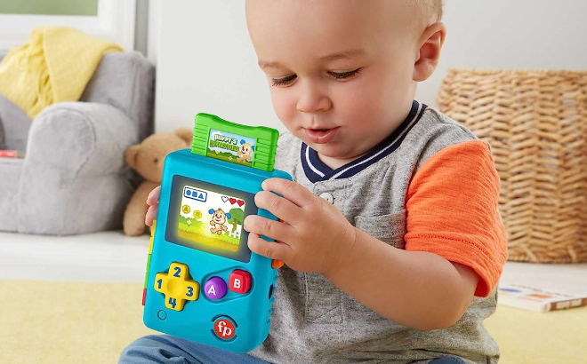 Baby Holding a Fisher Price Lil Gamer Pretend Video Game