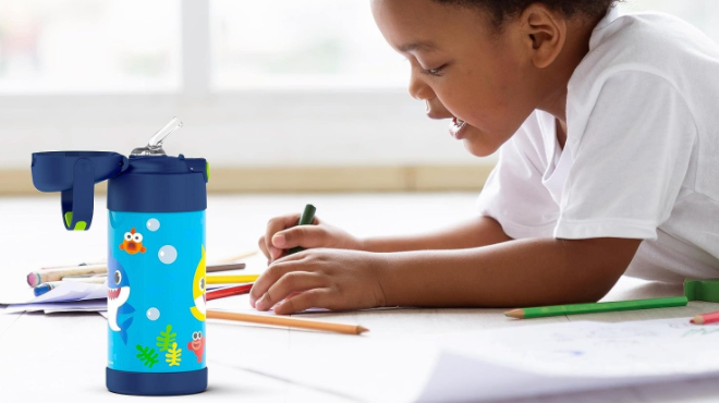 https://www.freestufffinder.com/wp-content/uploads/2023/08/Boy-Studying-with-Thermos-Baby-Shark-Kids-Straw-Bottle-12-oz-beside-him.png