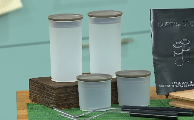 Curtis Stone 4 piece Canister Set on a Table