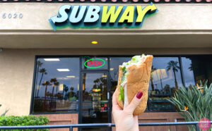 Hand Holding Half of a Subway Footlong