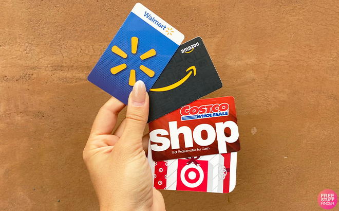 Hand Holding Walmart Amazon Costco and Target Gift Cards