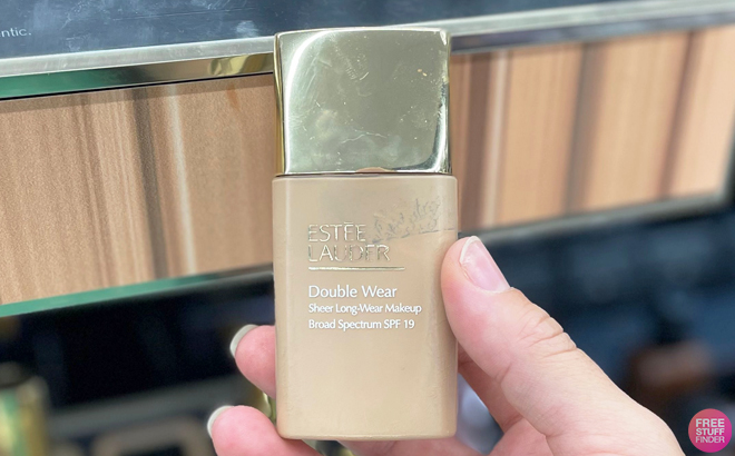 Hand Holding a Estee Lauder Double Wear Sheer Long Wear Foundation