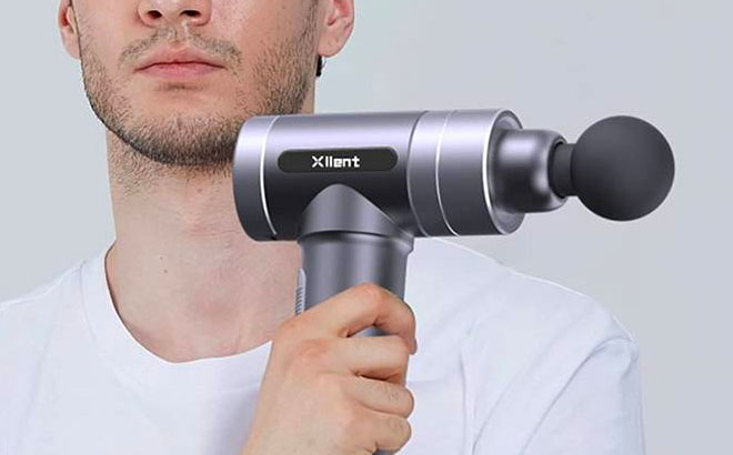 Man Holding a Xllent Massage Gun