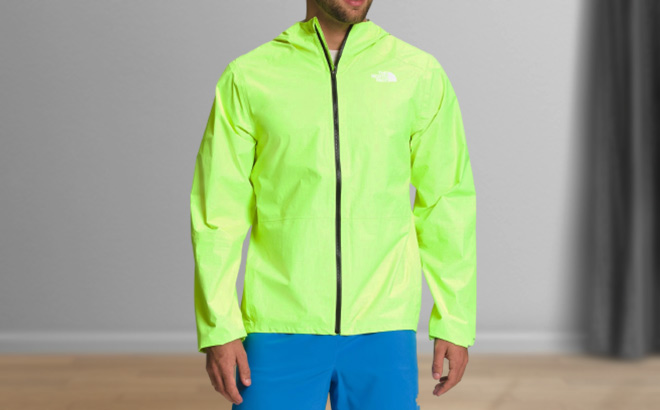 Man is Wearing The North Face Higher Run Jacket in Led Yellow color