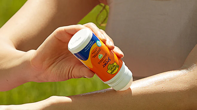 Person applying Banana Boat Roll On Sunscreen