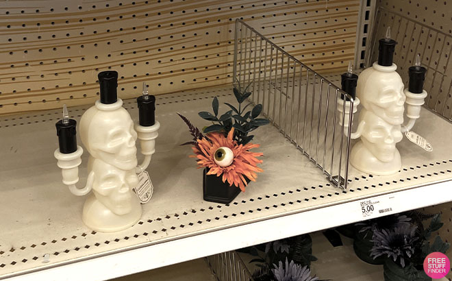 Skull Battery Operated Candelabra and Plastic Flower Arrangement on a Shelf