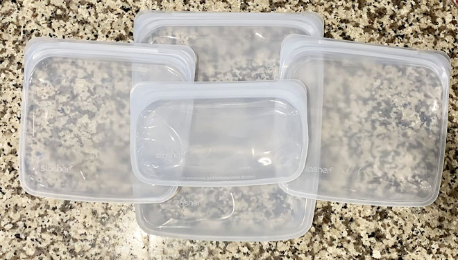 Stasher Reusable Silicone Storage Bag 4 Piece Set on a Table