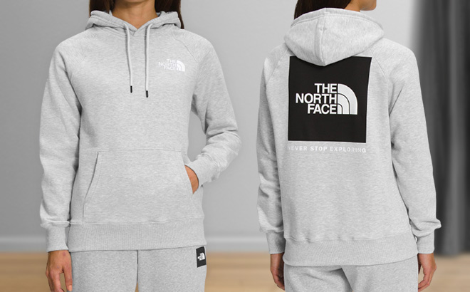 Woman is Wearing The North Face Hoodie in the Light Grey Heather color