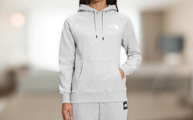 Woman is Wearing a The North Face Box Pullover Hoodie in the living room