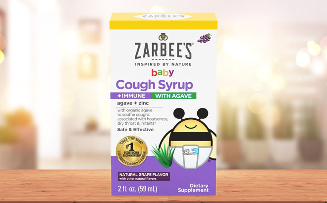 Zarbees Baby Cough Syrup 2 Ounce on a Wooden Table