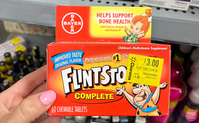 a Hand Holding Flintstones Gummies 60 Count Pack at Walmart