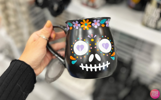 a Hand Holding Halloween Day of the Dead Mug