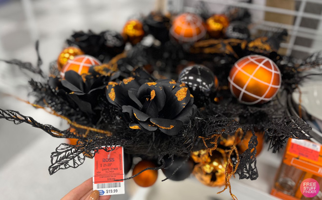 a Hand Touching Halloween Wreath Price Tag on Ross Store Shelf