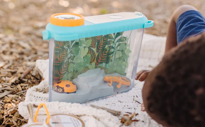 a Kid Playijng with a Lets Explore Terrarium Observations Play Set Outdoors