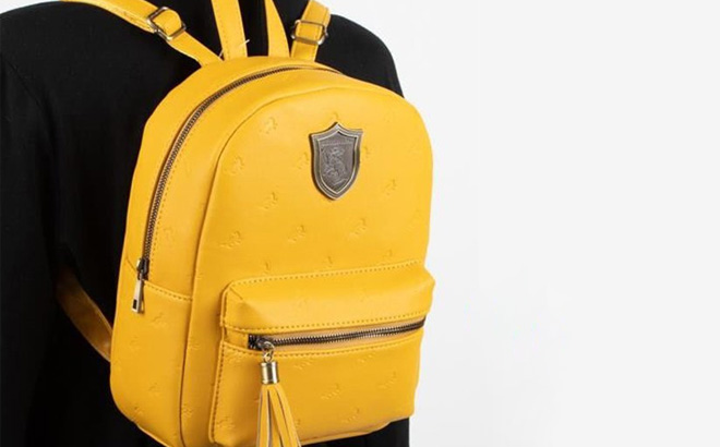 a Person Carrying a Bioworld Harry Potter Yellow Hufflepuff Crest Mini Backpack