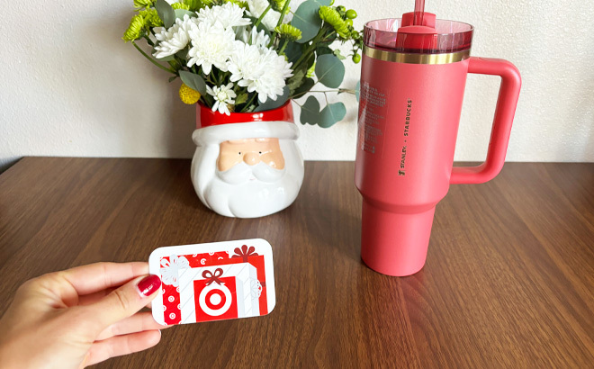 a Person Holding a Gift Card Next to the Stanley Tumbler