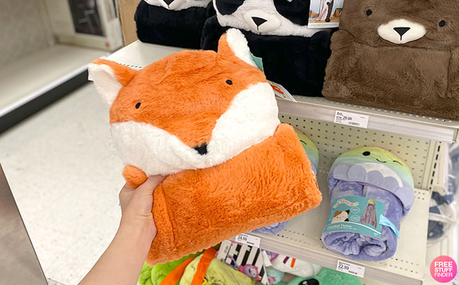 A Hand Holding a Pillowfort Kids Fox Hooded Blanket