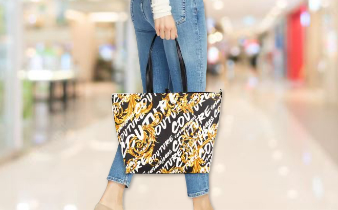 A Model Holding a Versace Graphic Leather Tote