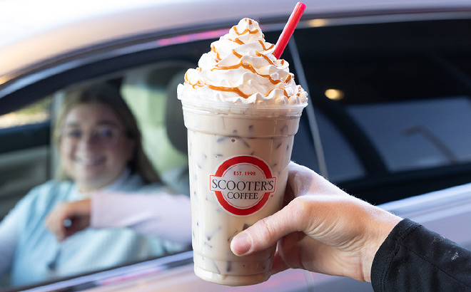 A Person Holding Scrooters Coffee