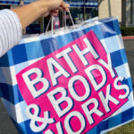 A Person Holding a Bath and Body Works Shopping Bag in Front of the Store