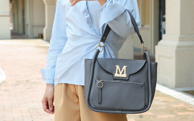 A Woman Carrying MKF Collection Chloy Hobo Bag in Denim